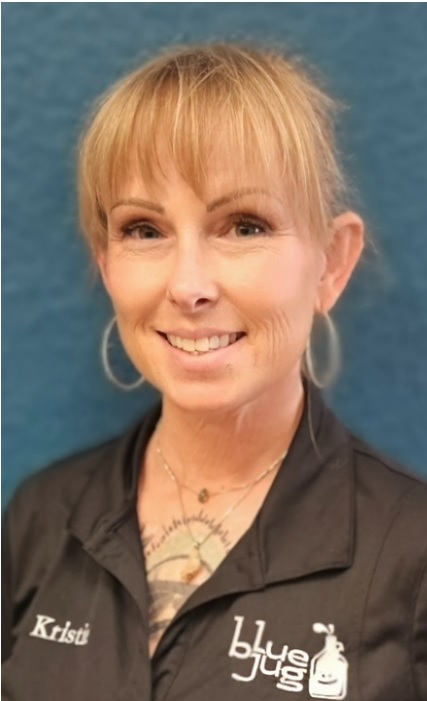 Professional headshot of woman in dark uniform